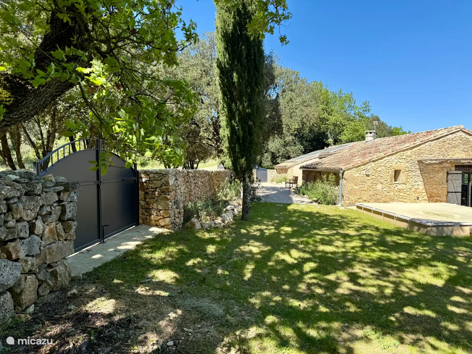 Visto desde el jardín, el estanque todavía está cubierto con una lona, es el comienzo de la primavera