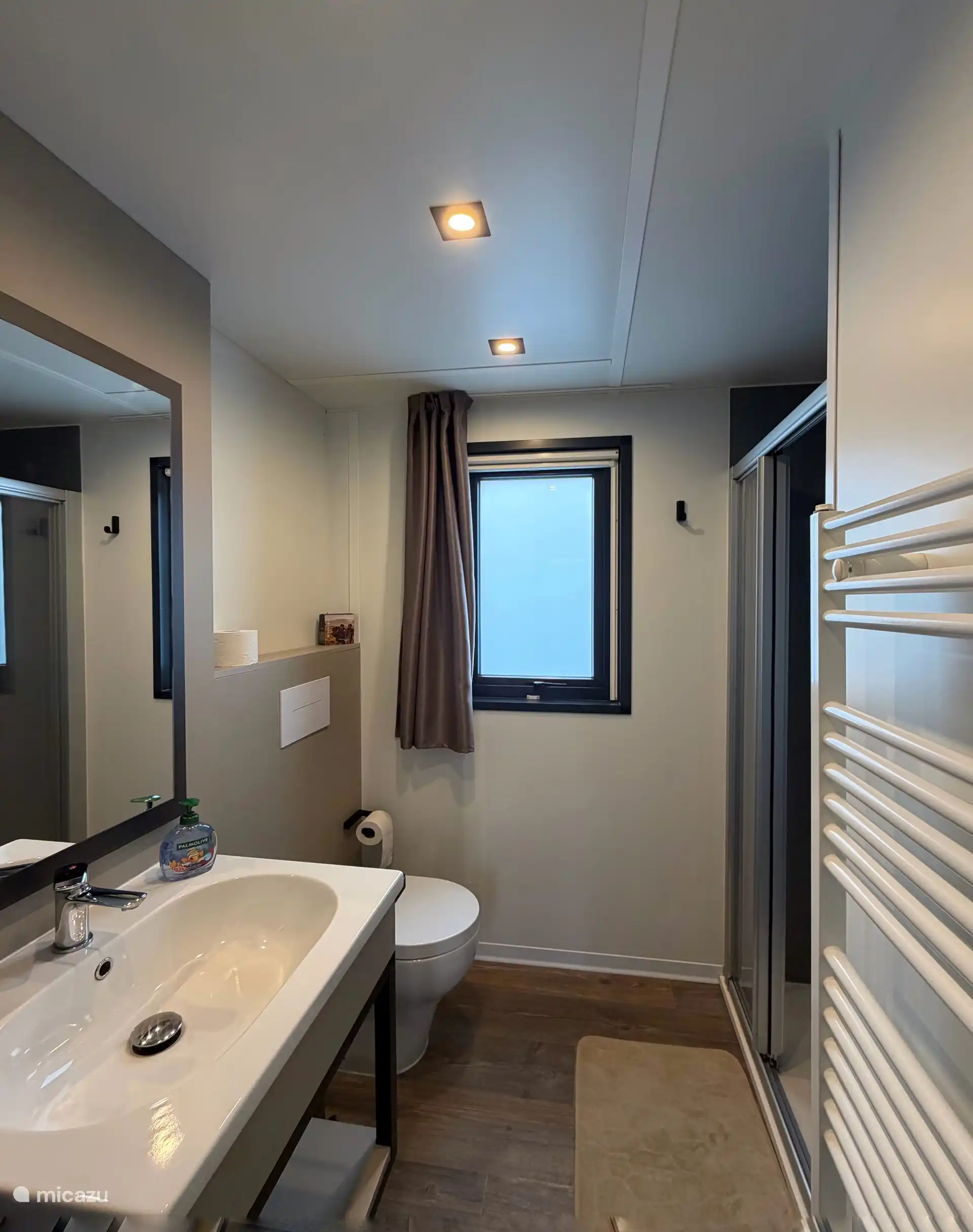 Luxurious bathroom with sink, toilet, shower and pleasantly heated with central heating