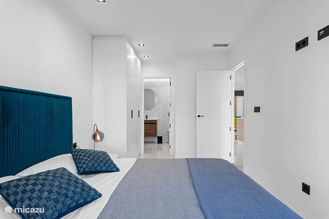 Spacious bedroom with large wardrobe.