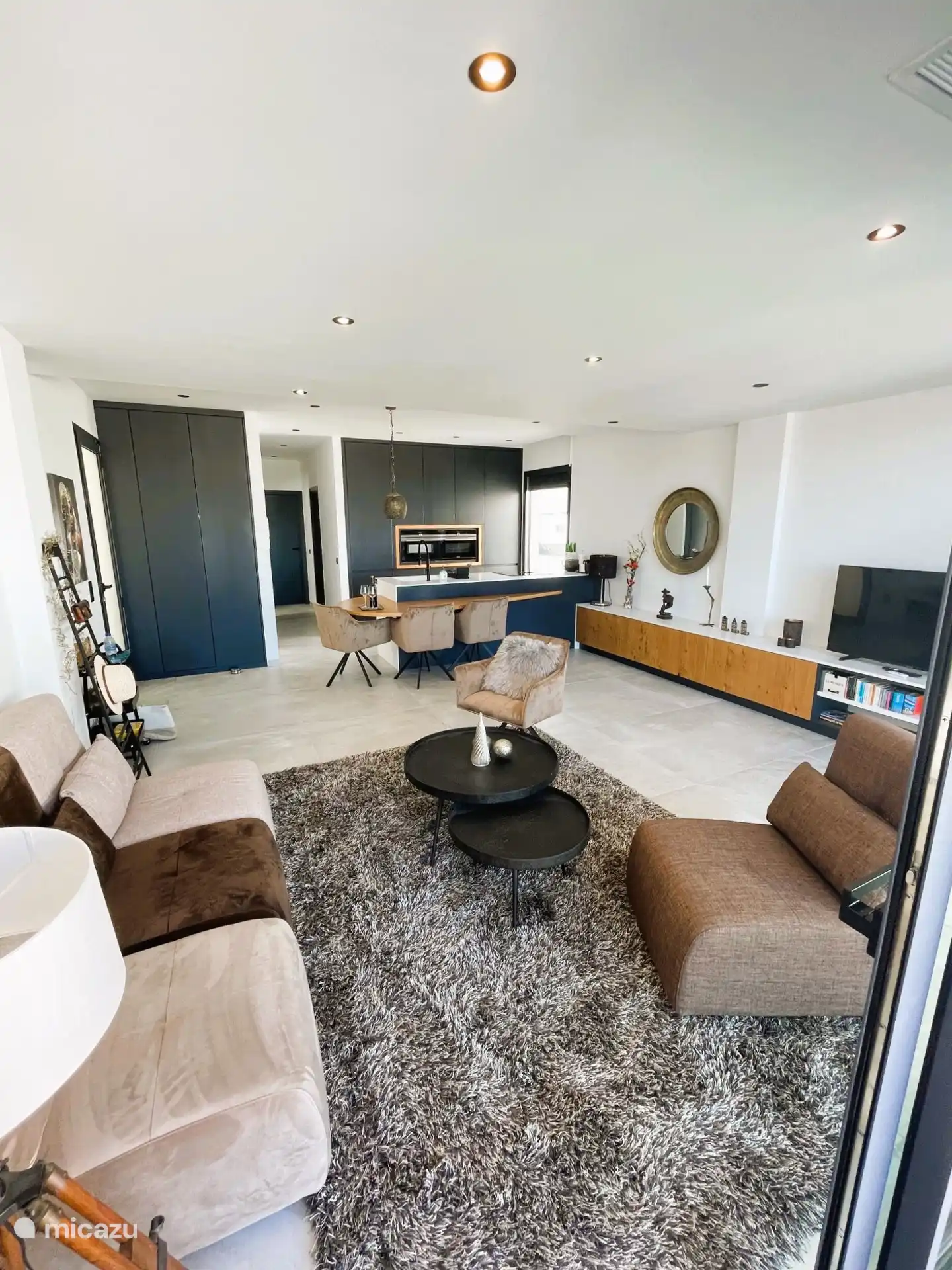 Spacious living room with comfortable sitting area and fully equipped kitchen