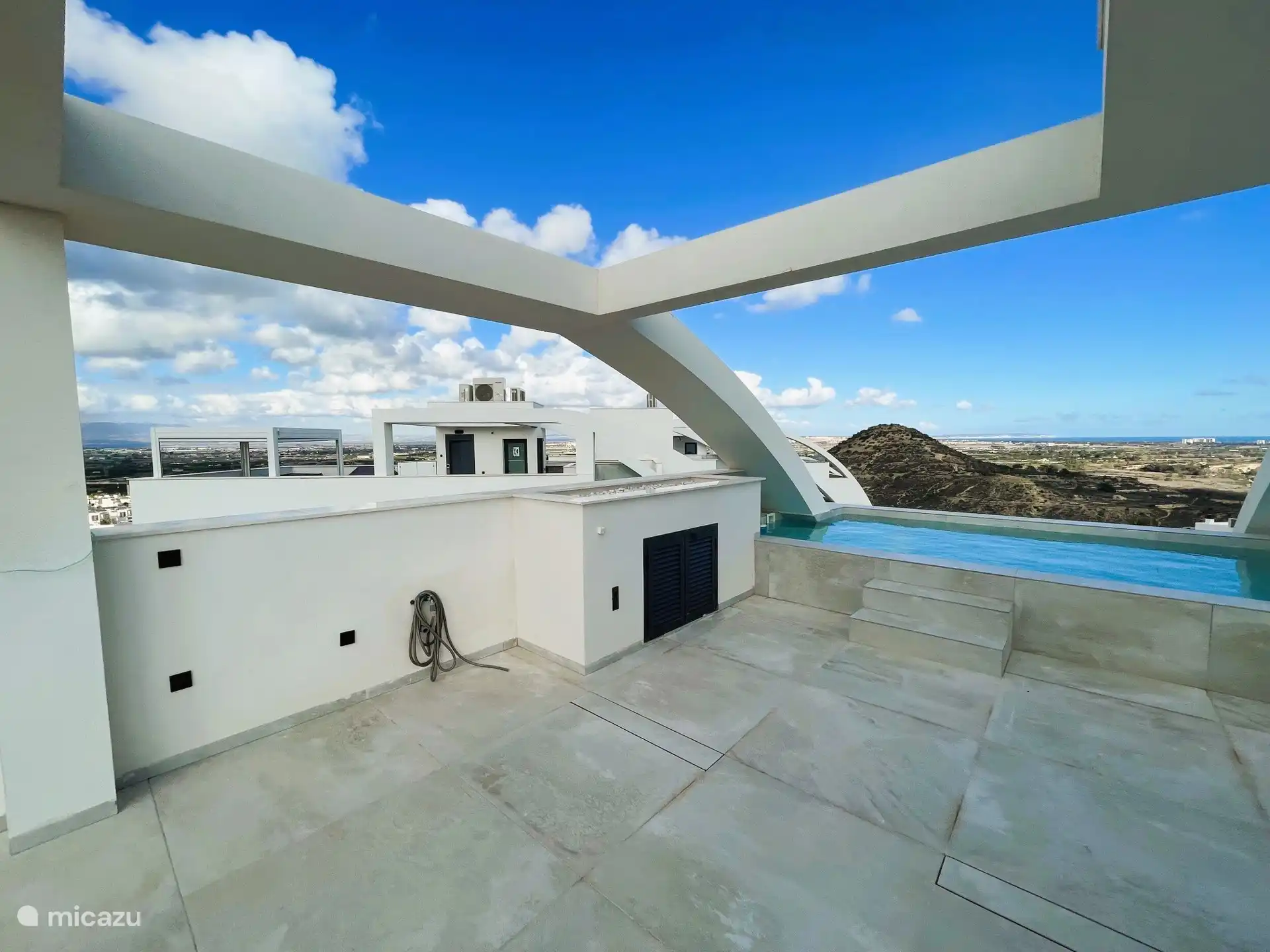 The large private roof terrace has a private swimming pool that overlooks the Recorral Natural Park, with distant views of the sea 
