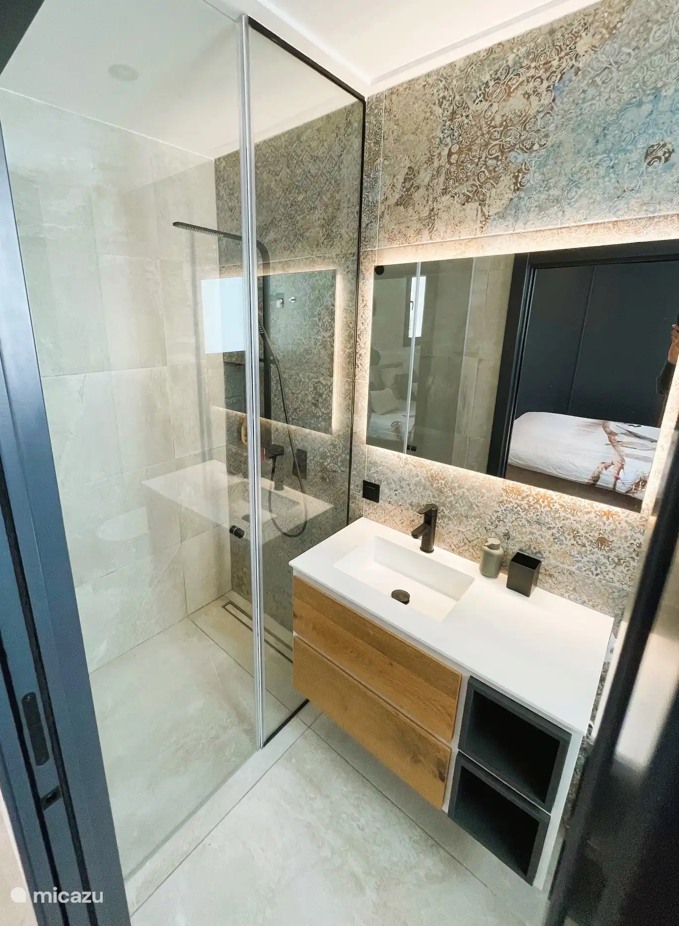 Beautiful modern bathroom with LED lighting. spacious shower, sink and toilet