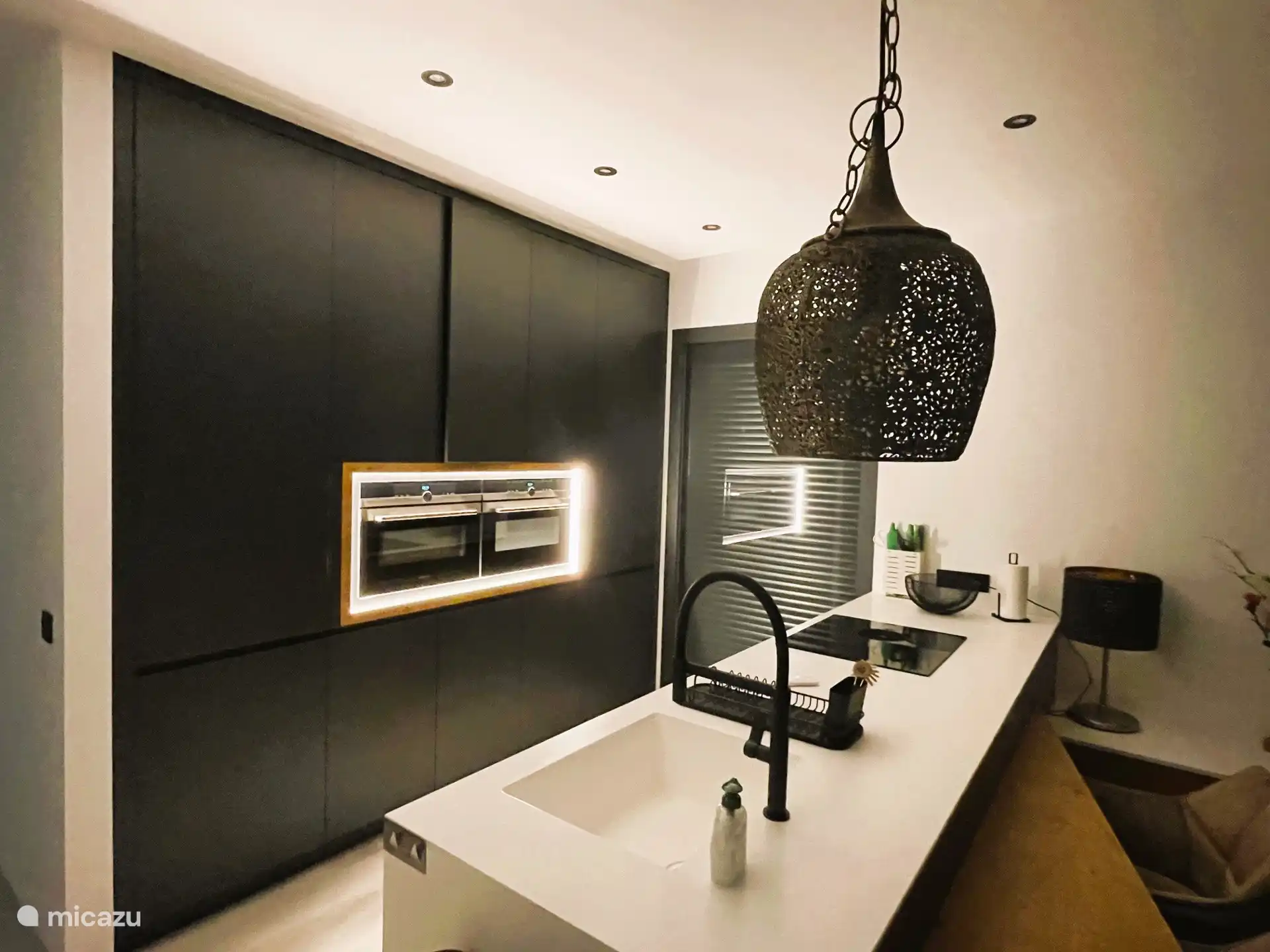 State-of-the-art kitchen with LED lighting and equipped with all conveniences such as a dishwasher and double oven.