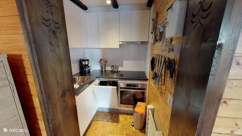 Modern kitchen with dishwasher and induction hob. 