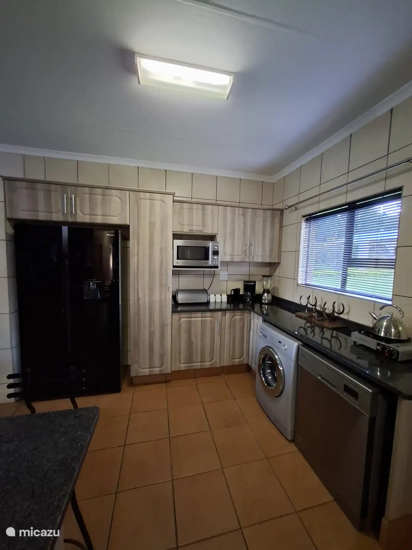 Large kitchen with dishwasher and washing machine.