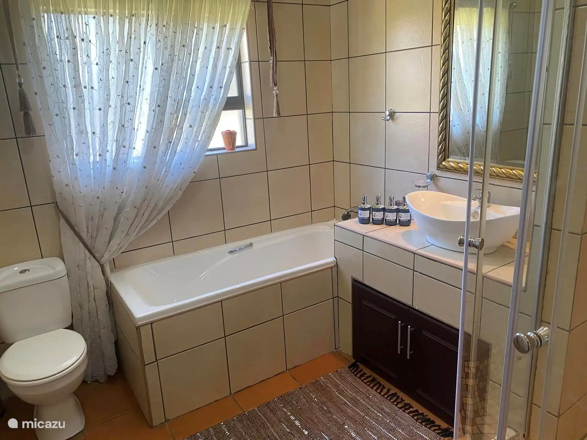 Second bathroom with bath and shower.