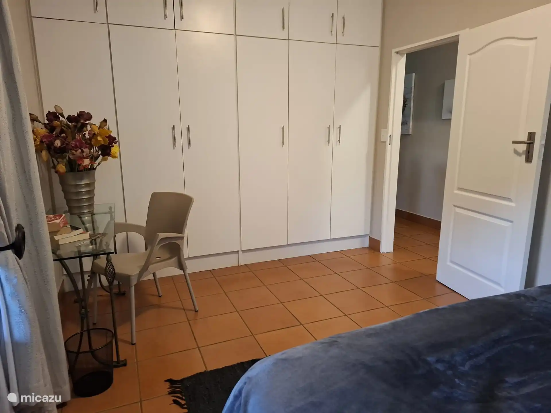 Third room with queen size bed and desk.