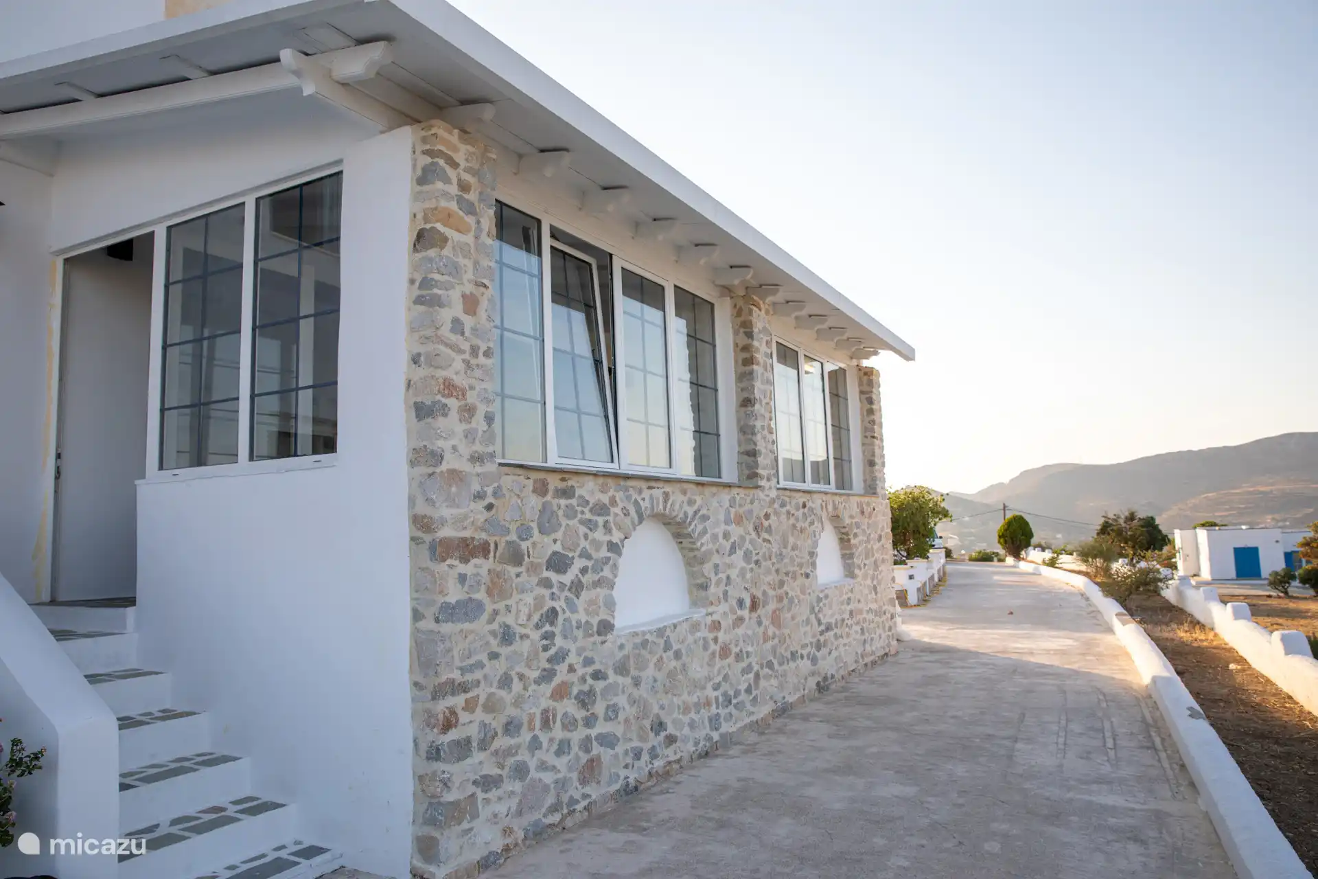 Front of the house with the path towards the road. 
