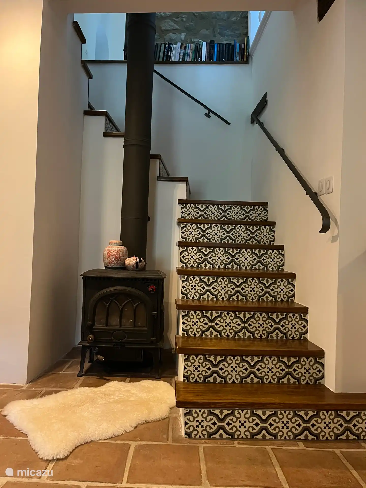 Estufa de leña y escaleras al primer piso de la Maison du Parc.