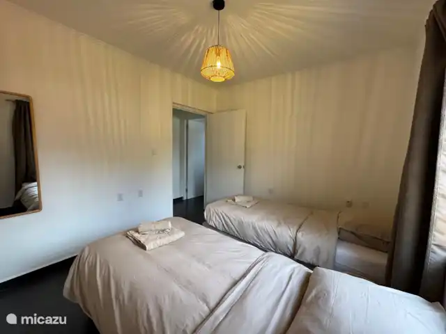 Location de Vacances Curaçao, Banda Ariba (est), Jan Thiel, maison de vacances - Casita Apapacho Puru Jan Thiel  2ème chambre avec deux lits séparés avec sommier tapissier (90x200) avec couettes séparées (140x210) qui peuvent également être attachées l’une à l’autre comme un lit double. Climatisation, miroir et armoire encastrée avec suspension et pose.
