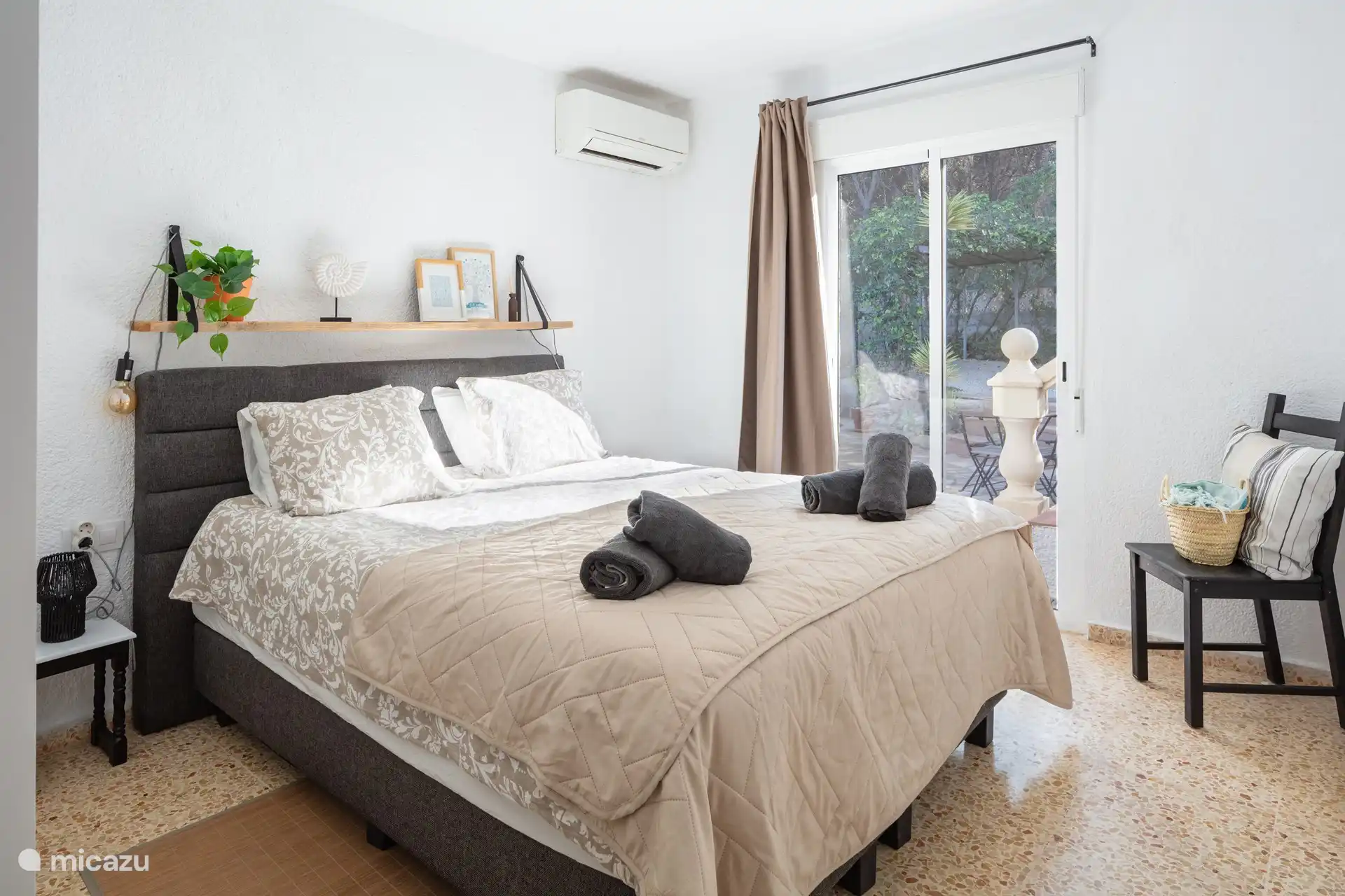 Bedroom 3. This room has sliding doors that lead to the pool/jacuzzi. There is a large wardrobe.