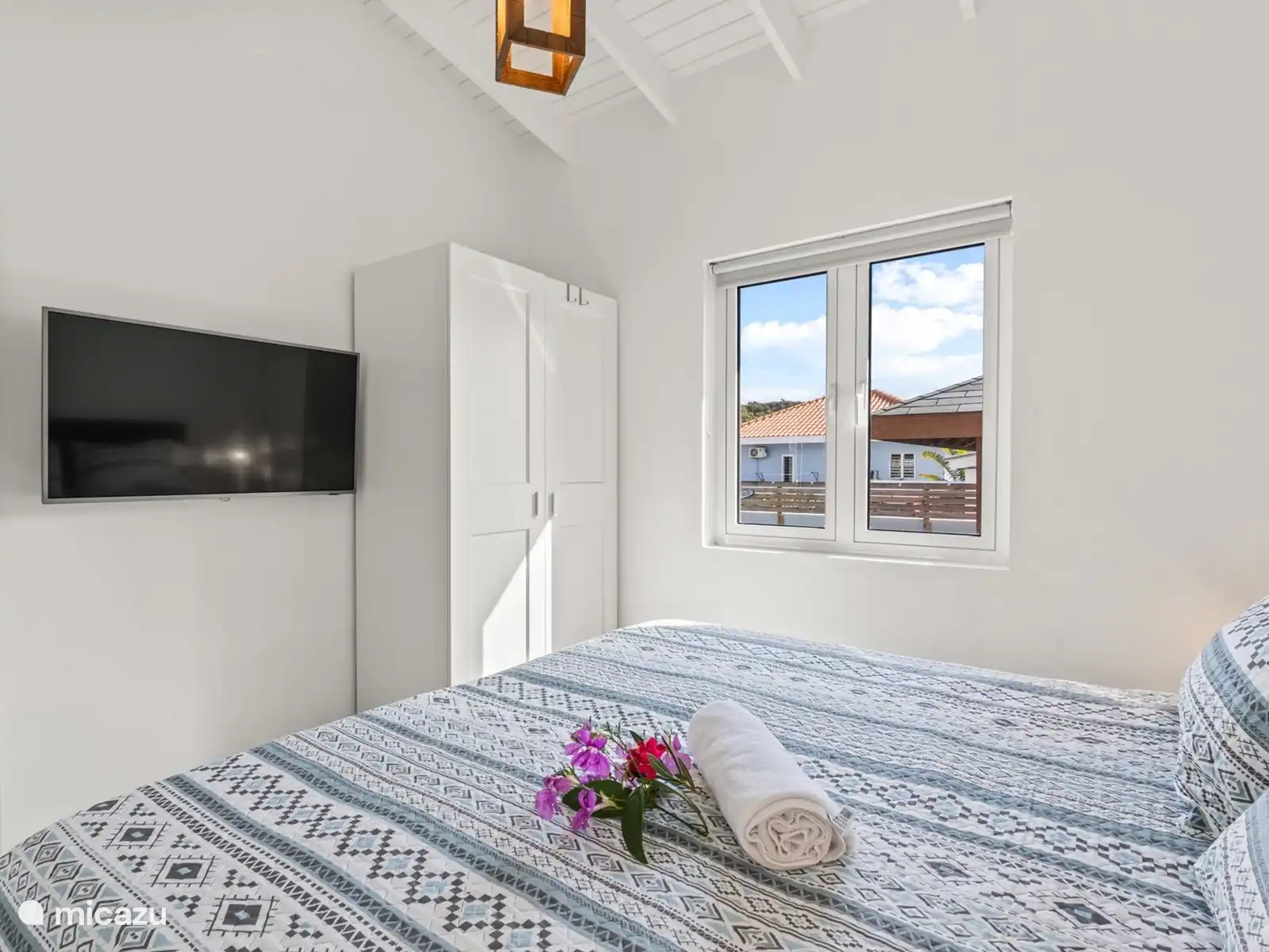 Bedroom with double bed and TV