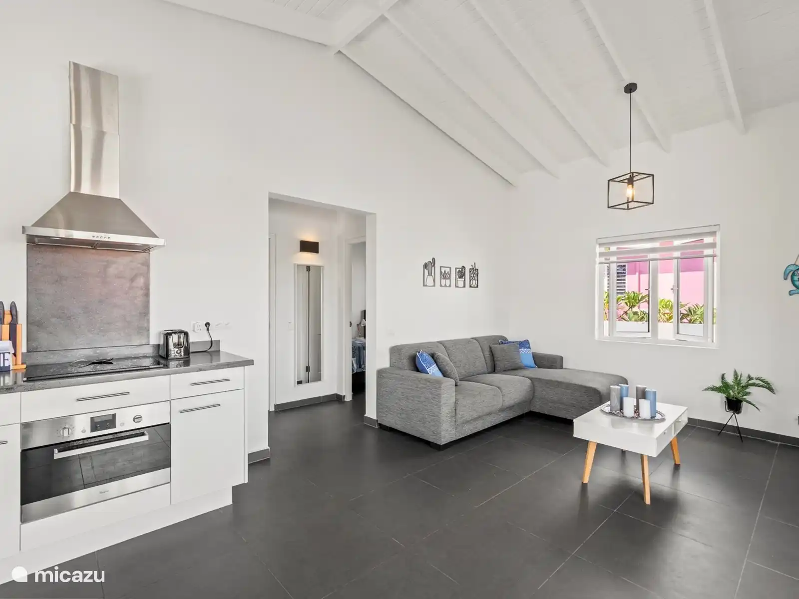 Sitting area with extra fridge, safe and TV.