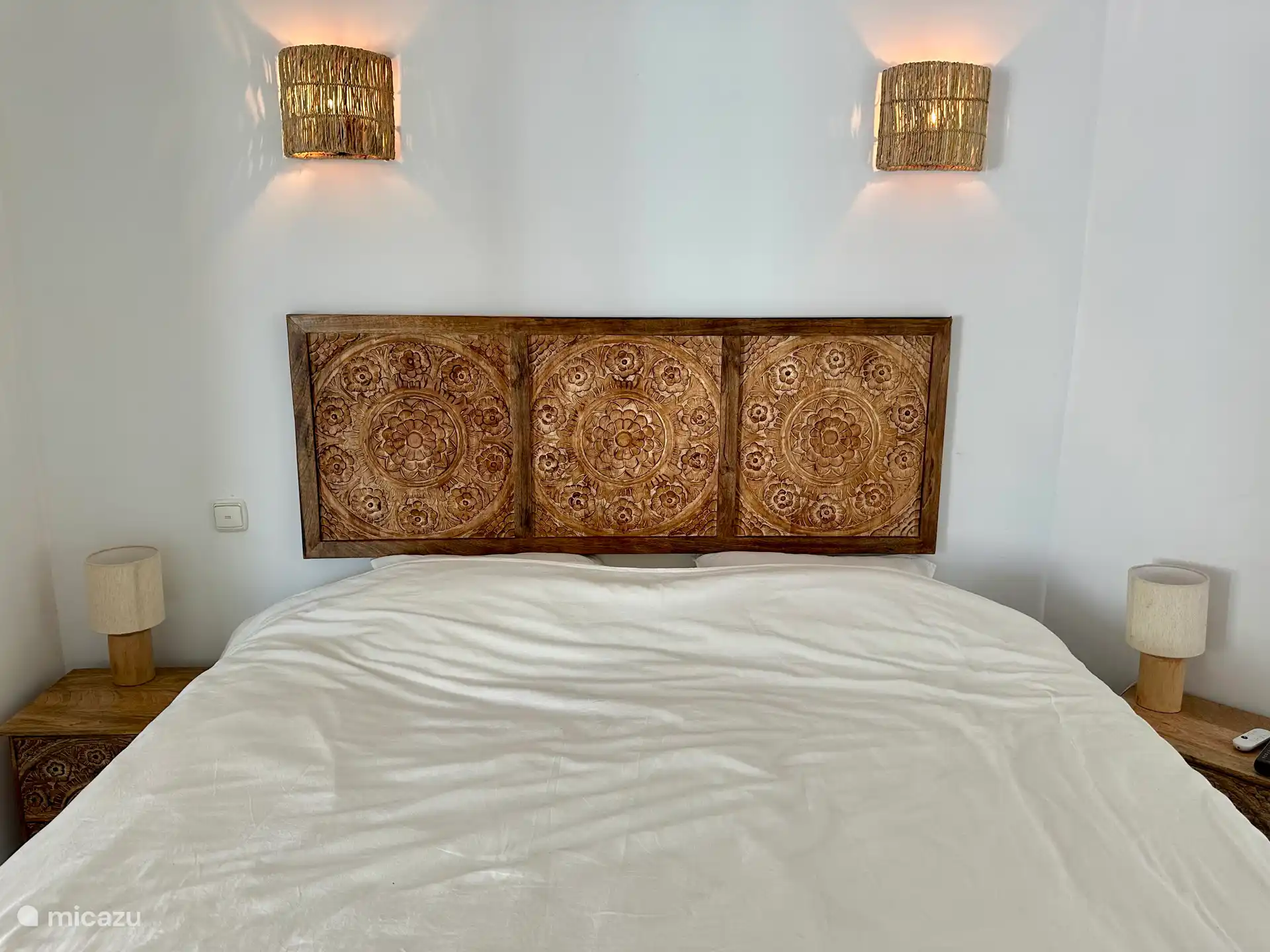 Schlafzimmer 1, Doppelbett mit eigenen Nachttischen, Garderobenständer, Wäschekorb, Smart-TV, Chromecast, Ventilator, Fenster.