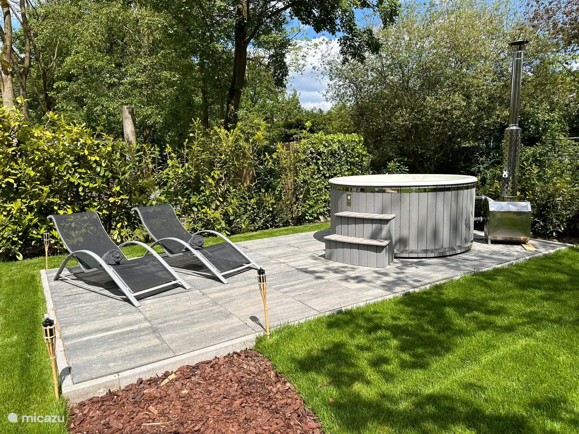 Hot tub terrace with two sunbeds