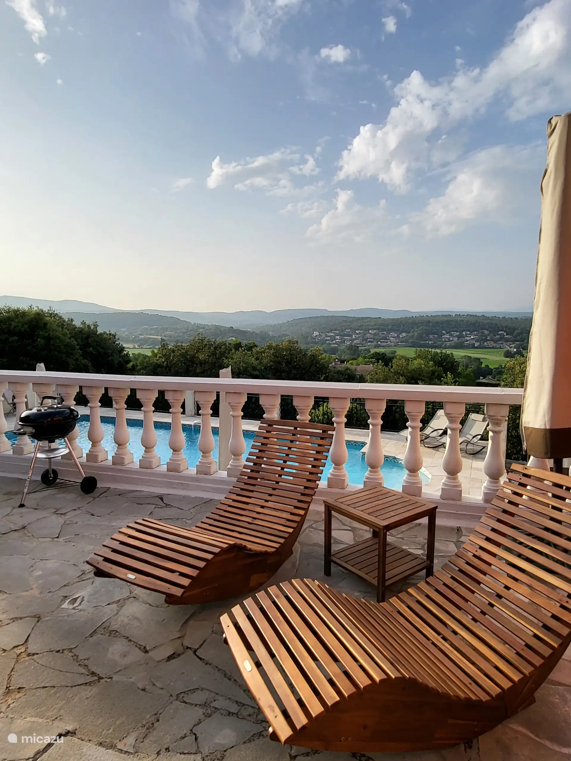 wooden sunbeds with a view of the hills