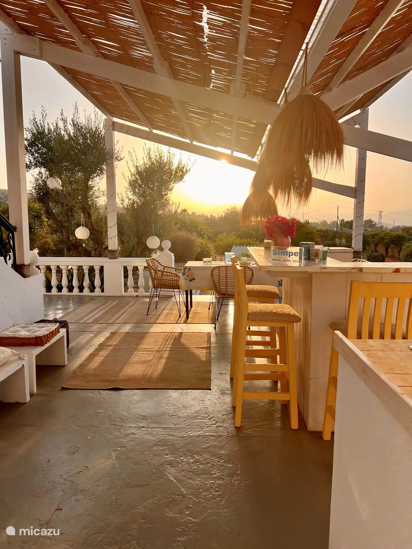 Covered terrace with outdoor bar, fridge and seating area to enjoy the beautiful sunsets