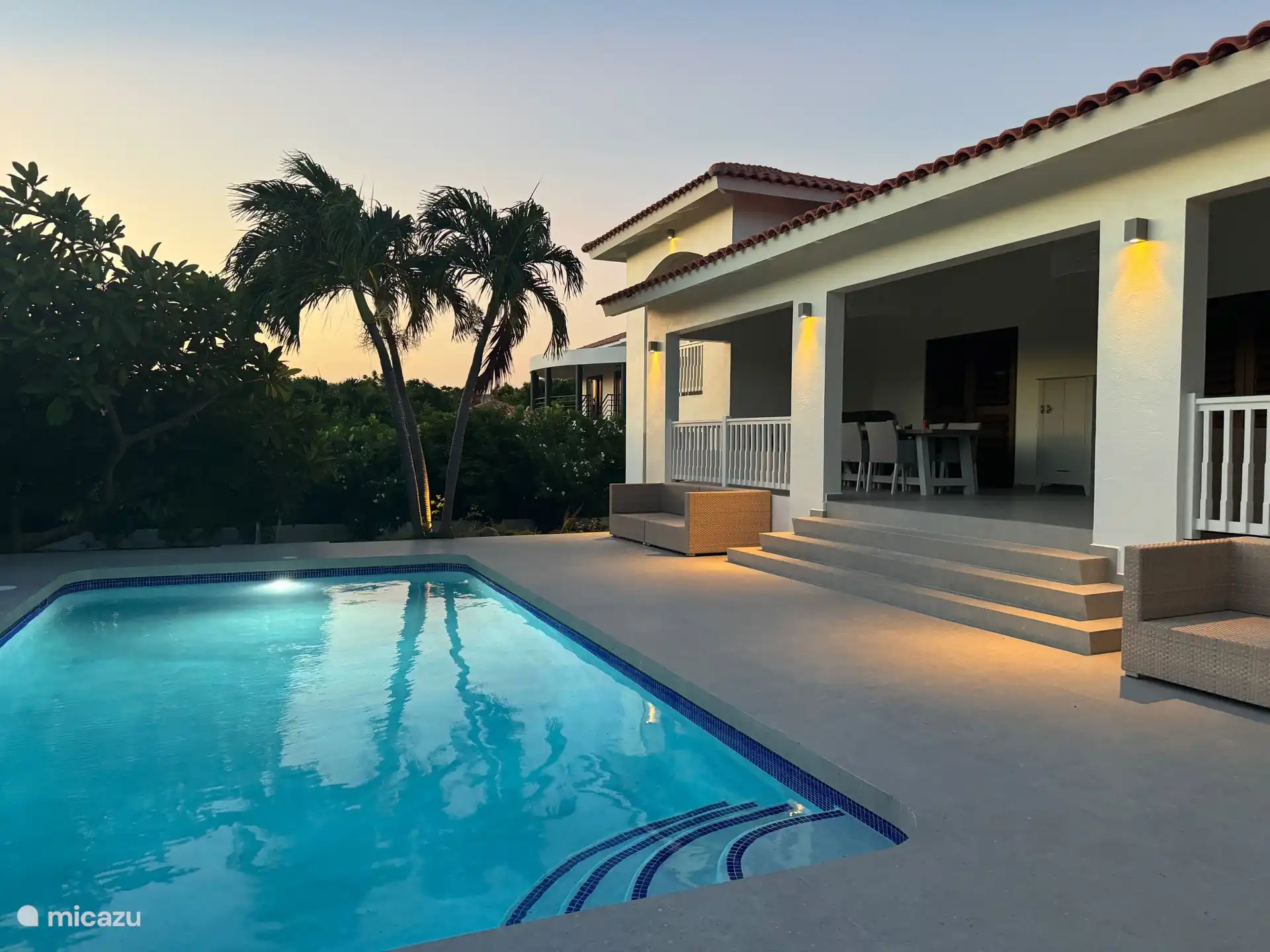 Pool and veranda during golden hour. 