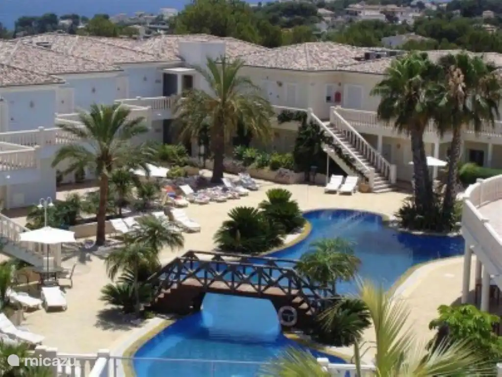 Vue sur la piscine lagon avec transats pour tous.