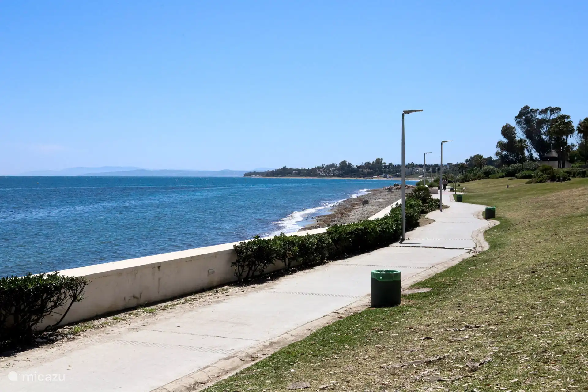 Wide promenade with a view of the village and the coast