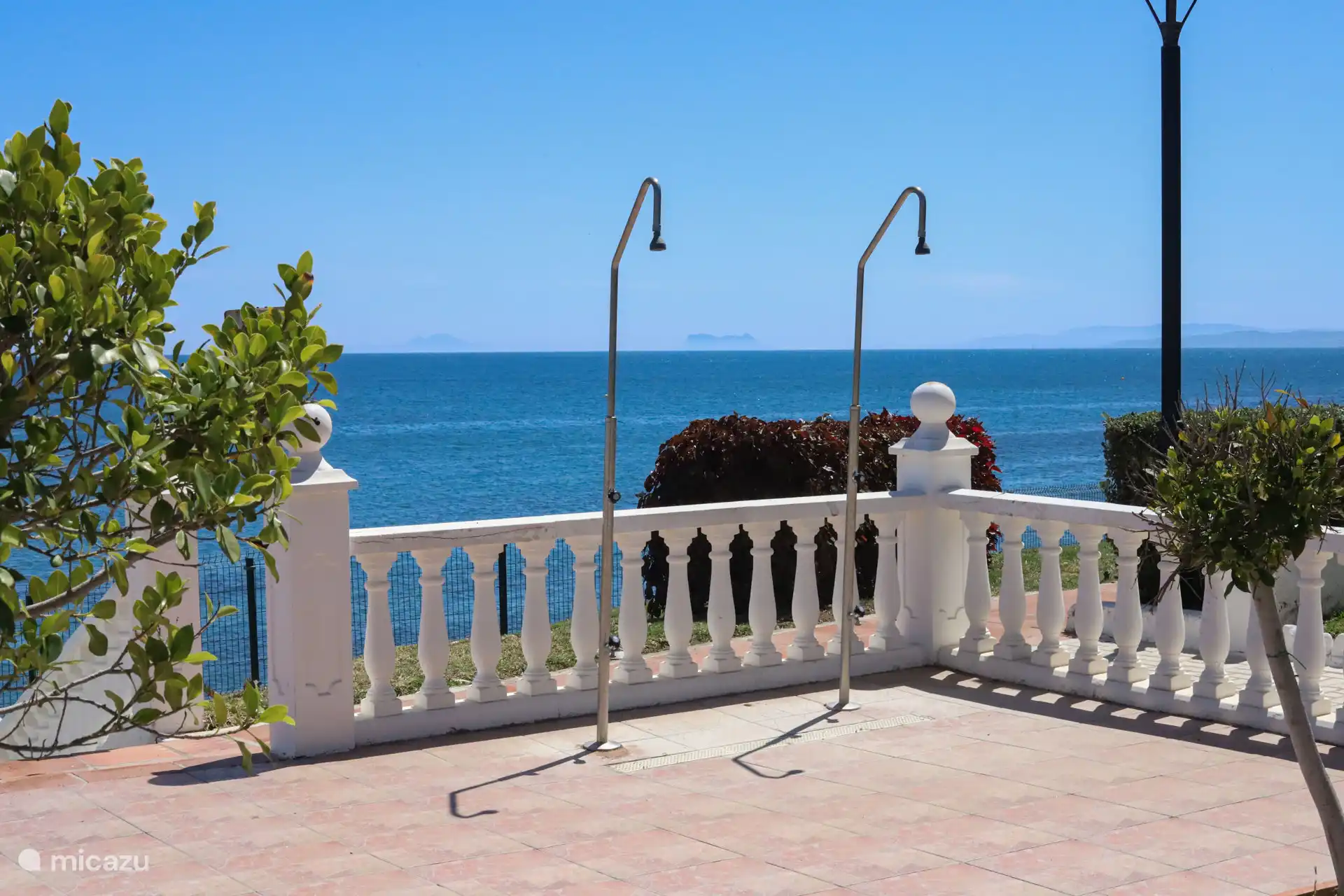 Terrace with balustrade and sea views and showers 