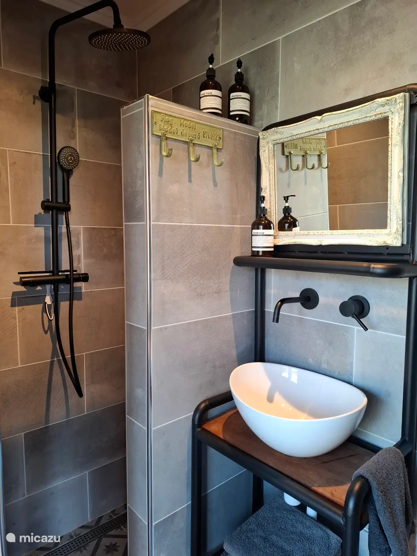 Kompaktes Badezimmer mit Waschbecken, Dusche und WC. Handtücher sowie Shampoo und Duschgel liegen für Sie bereit.