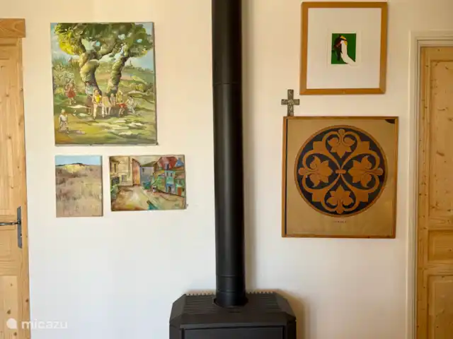 Las cigarras de St-Quentin-la-Poterie en Francia, Gard, Saint-Quentin-la-Poterie - casa vacacional la estufa de la sala de estar rodeada de pinturas y dibujos