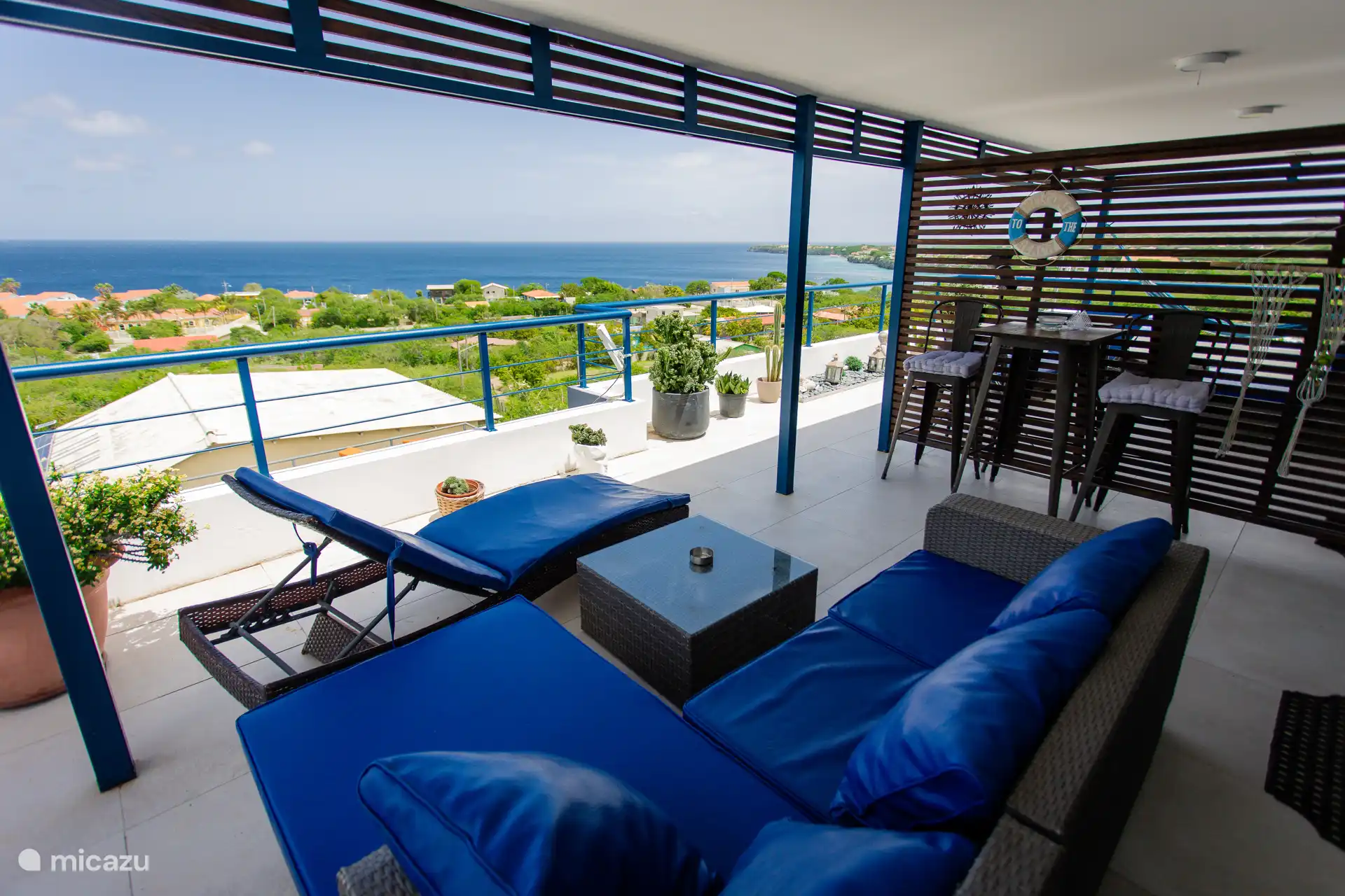 Relax in the shade on comfy lounge chairs with a stunning Caribbean Sea view right in front of you