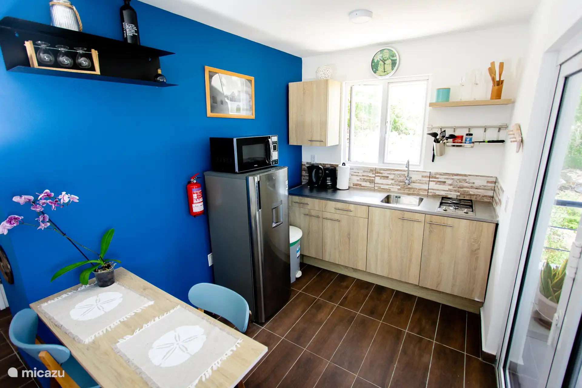 Open kitchen with direct access to the terrace — cook with a view of green hills and ocean breeze.