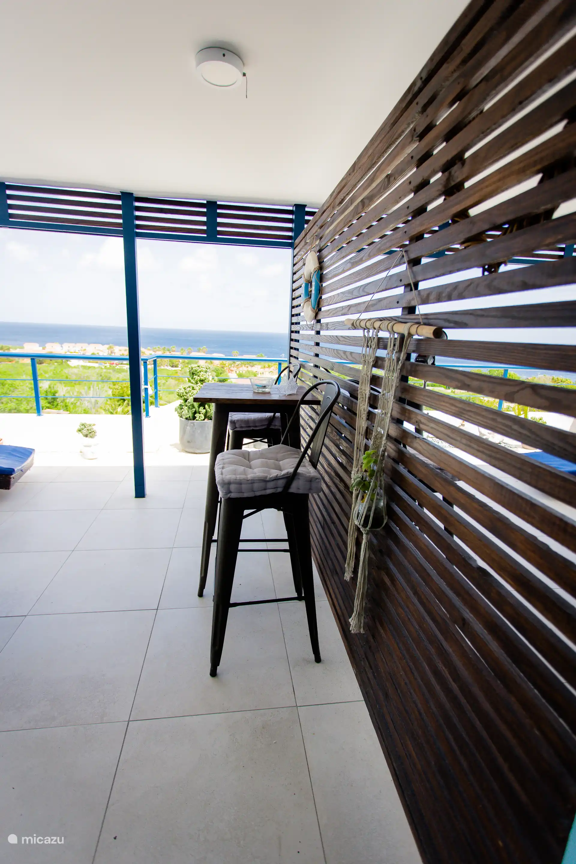 Cozy bar table for two with ocean views — ideal for a drink, snack, or working in tropical peace.
