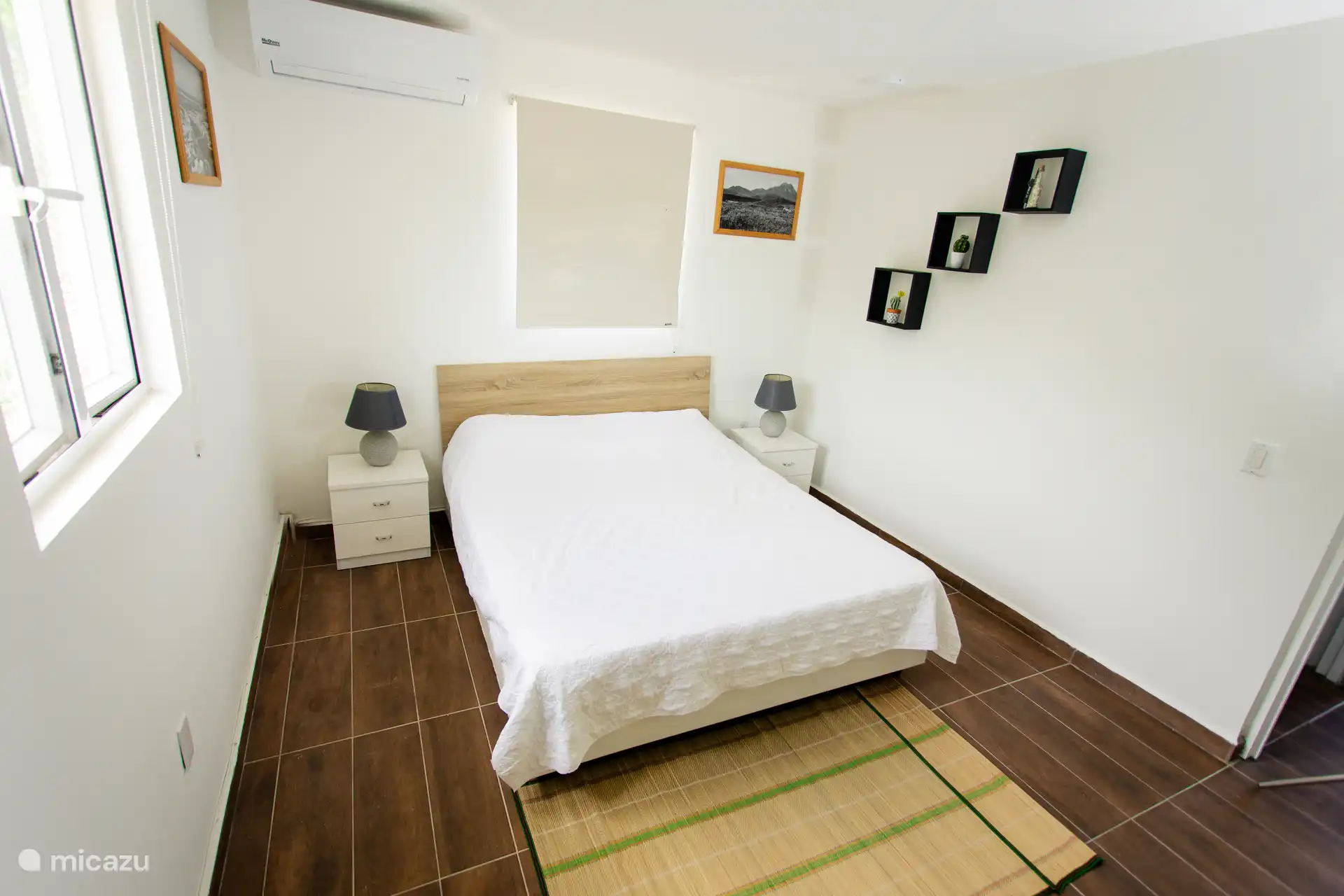 Comfortable queen-size bed with bedside tables and relaxing decor for a great night’s sleep.