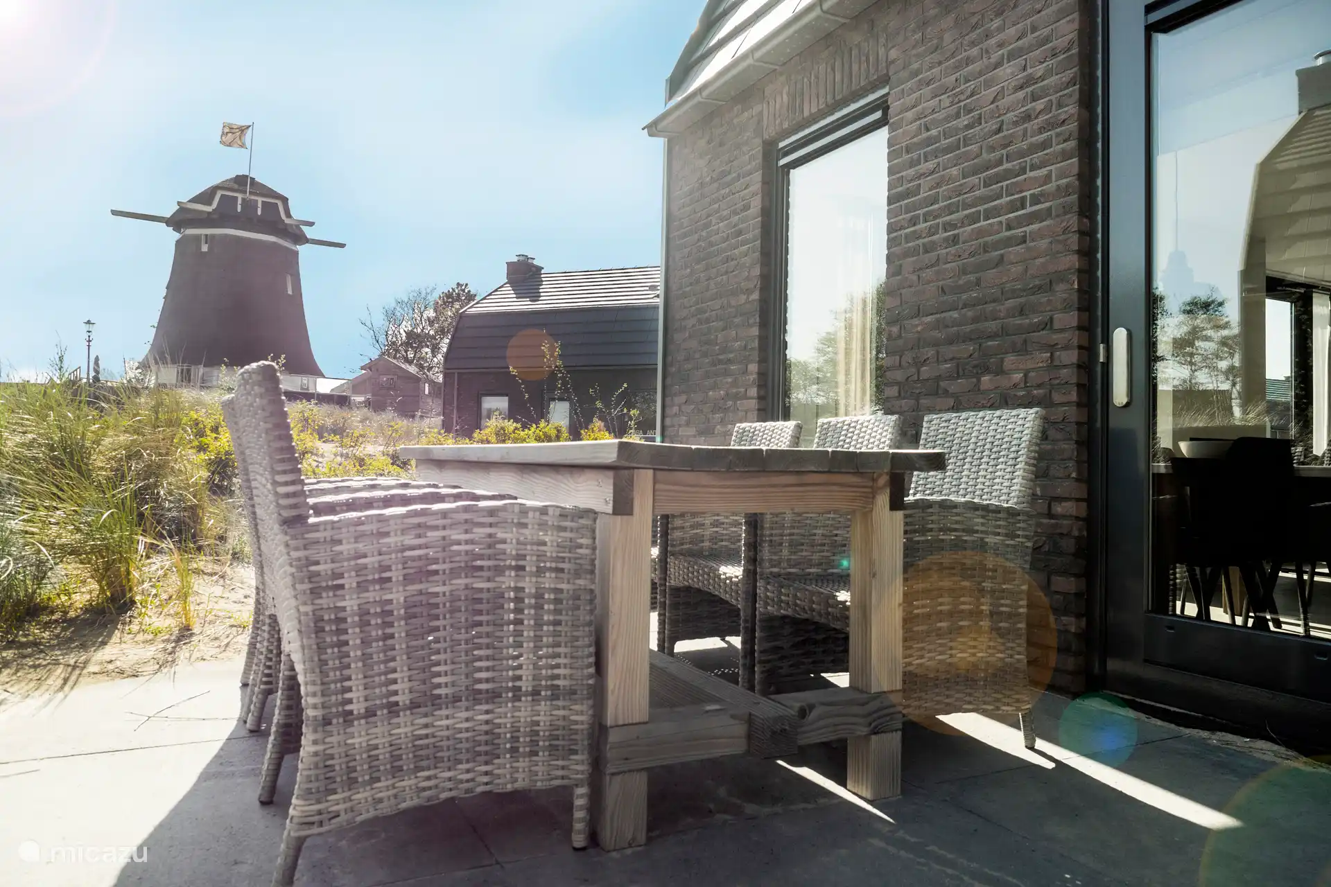 Garden table with a view of the Mill of Egmond