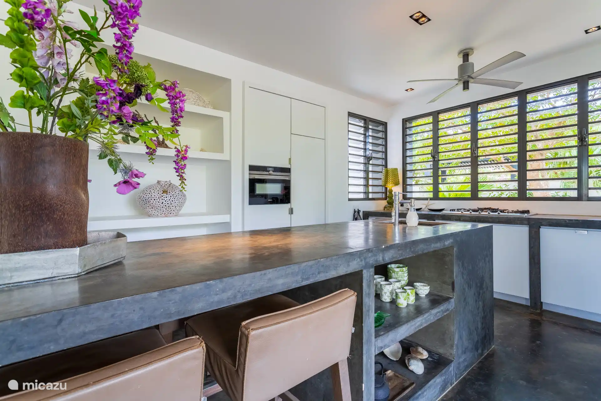 The luxury kitchen is fully equipped with a spacious cooking island.