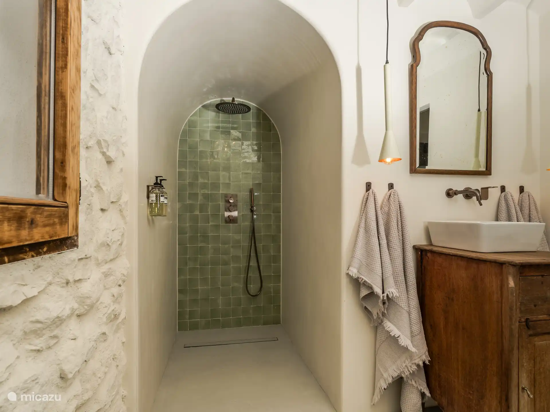 bathroom with rain shower and tasteful details 