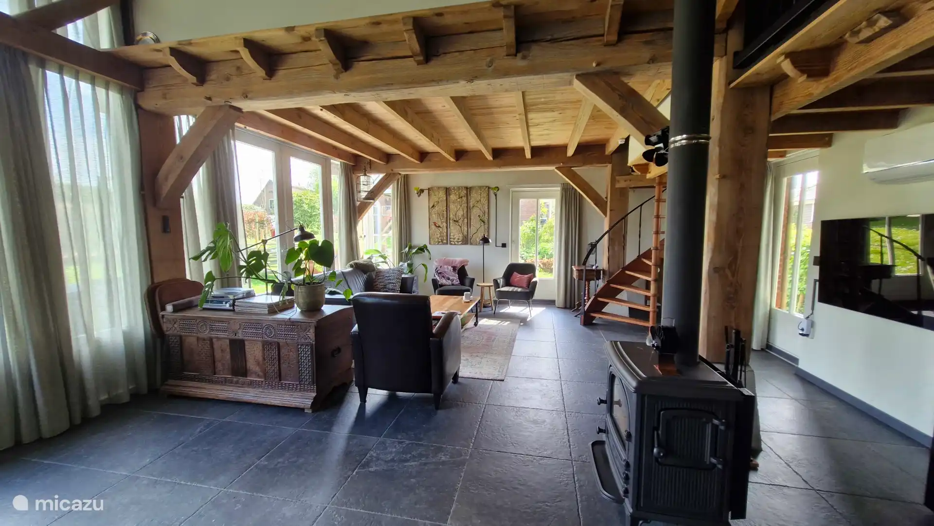 Lovely open sitting area with sofa and chairs, television (400 channels) and wood stove.