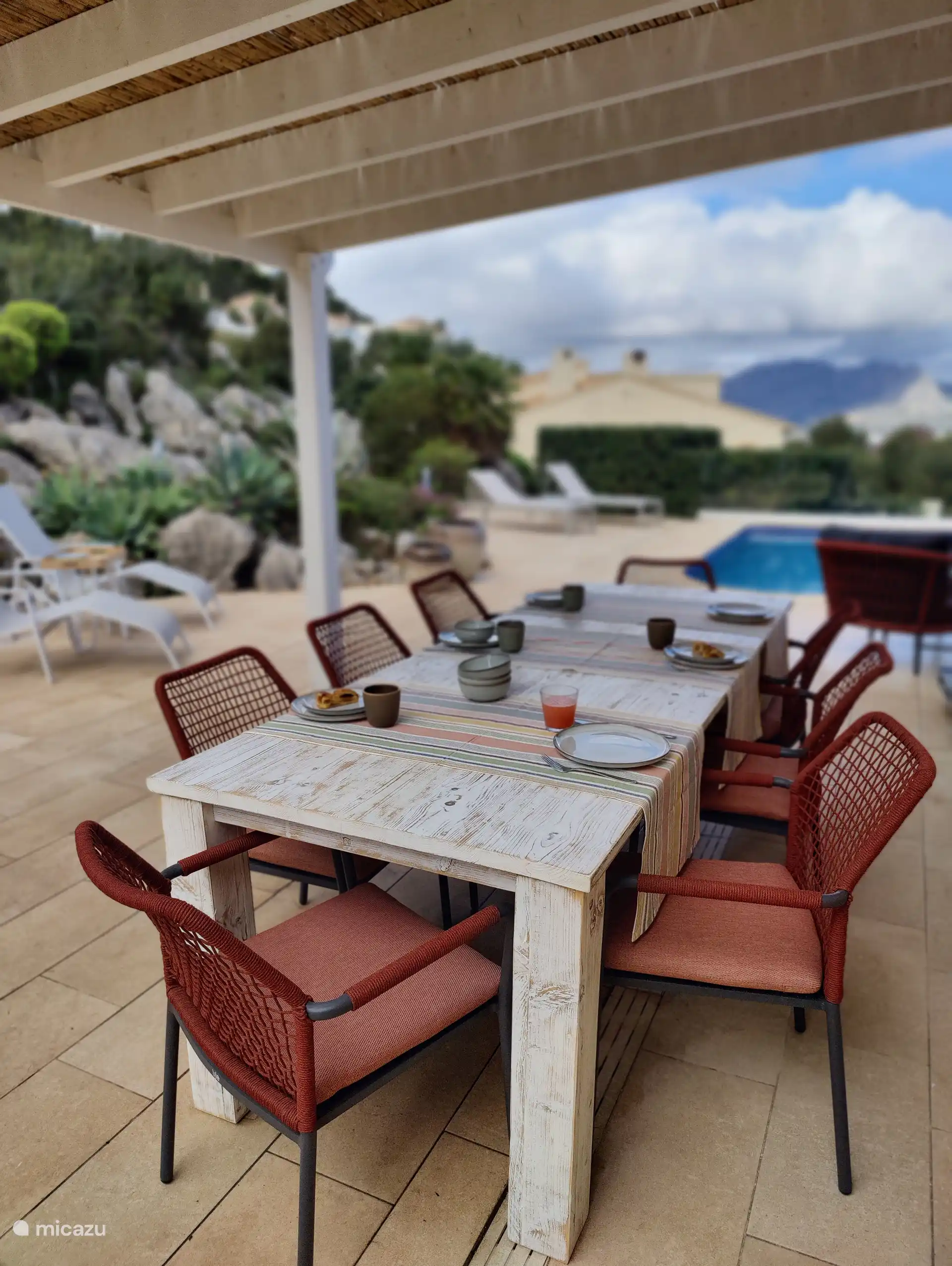 Cozy dining under the pergola, with a view of the pool.