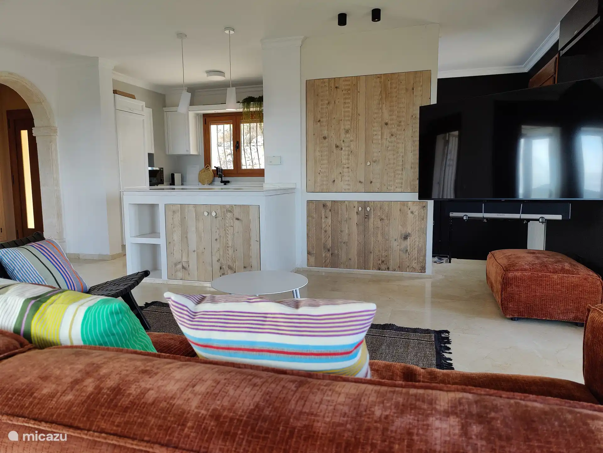 Living room with large fold-out flat screen (65 inches).