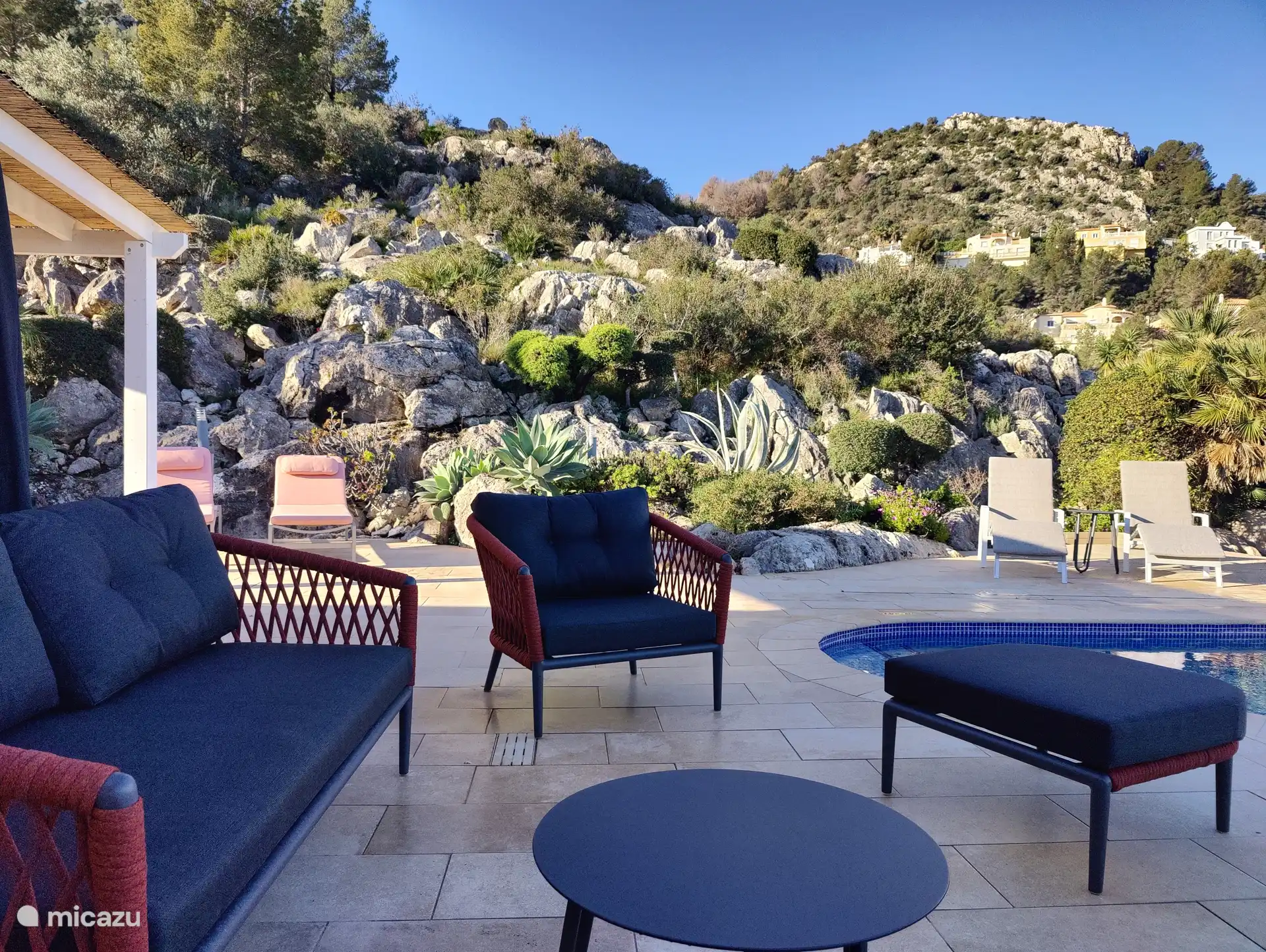 Spacious terrace (240m²) with a view of the rock garden, the swimming pool and the surrounding area.
