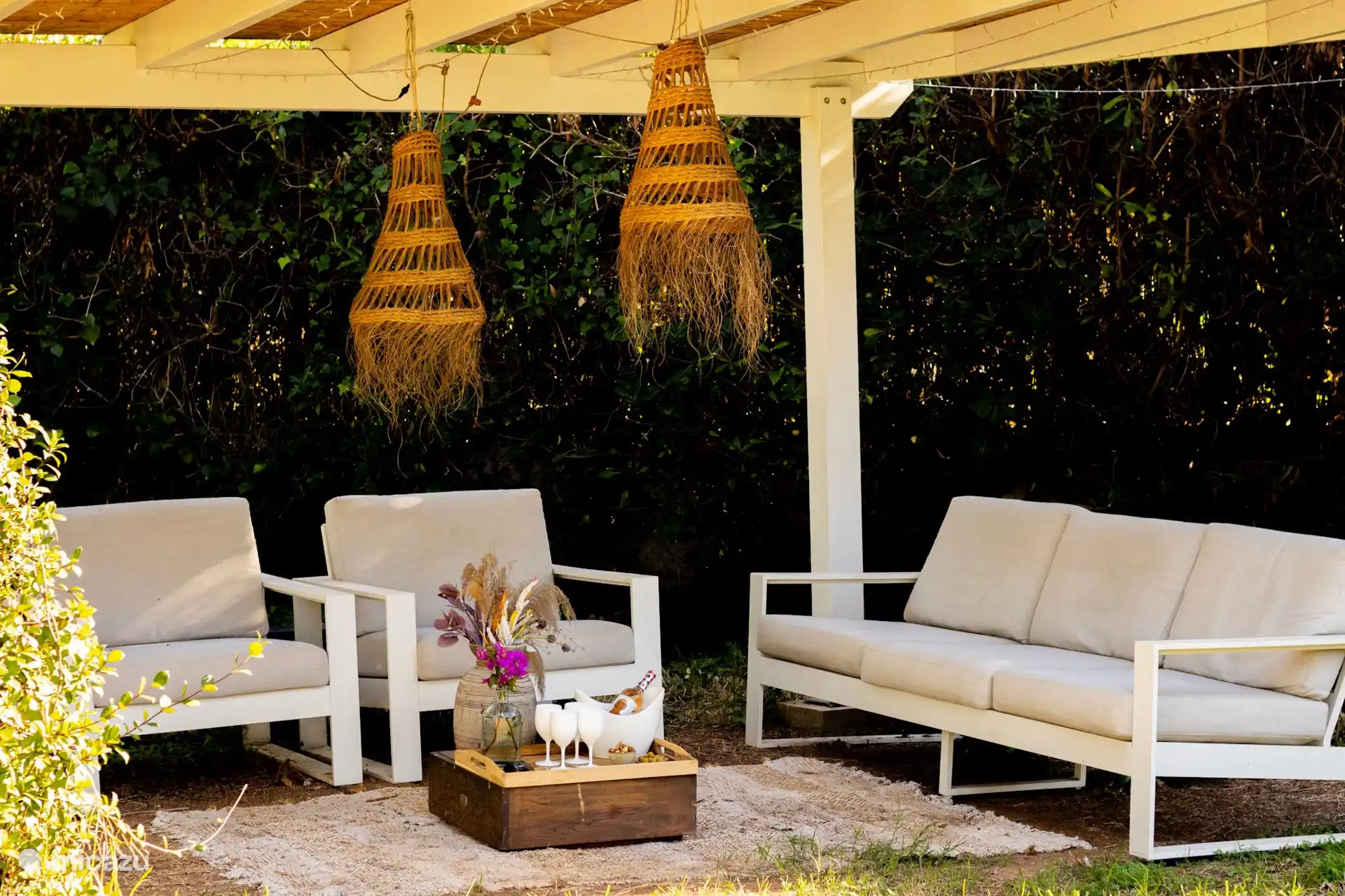 Under the covered veranda at the back of the garden it is wonderful to relax at any time of the day with a book or in the hammock.