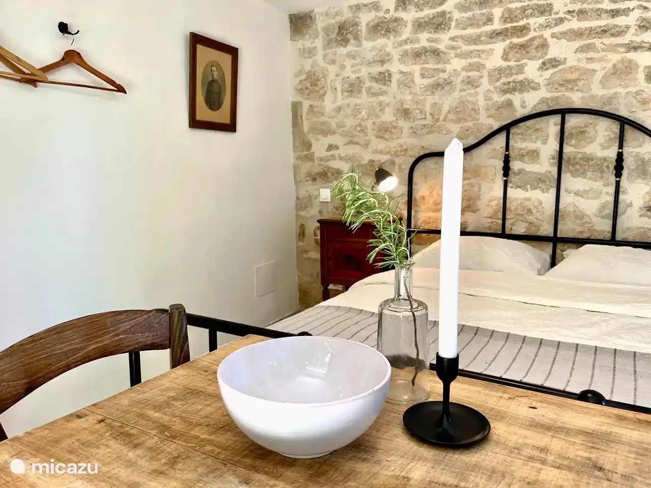 The comfortable double bed of the studio, which is located under the terrace near the living room/kitchen.