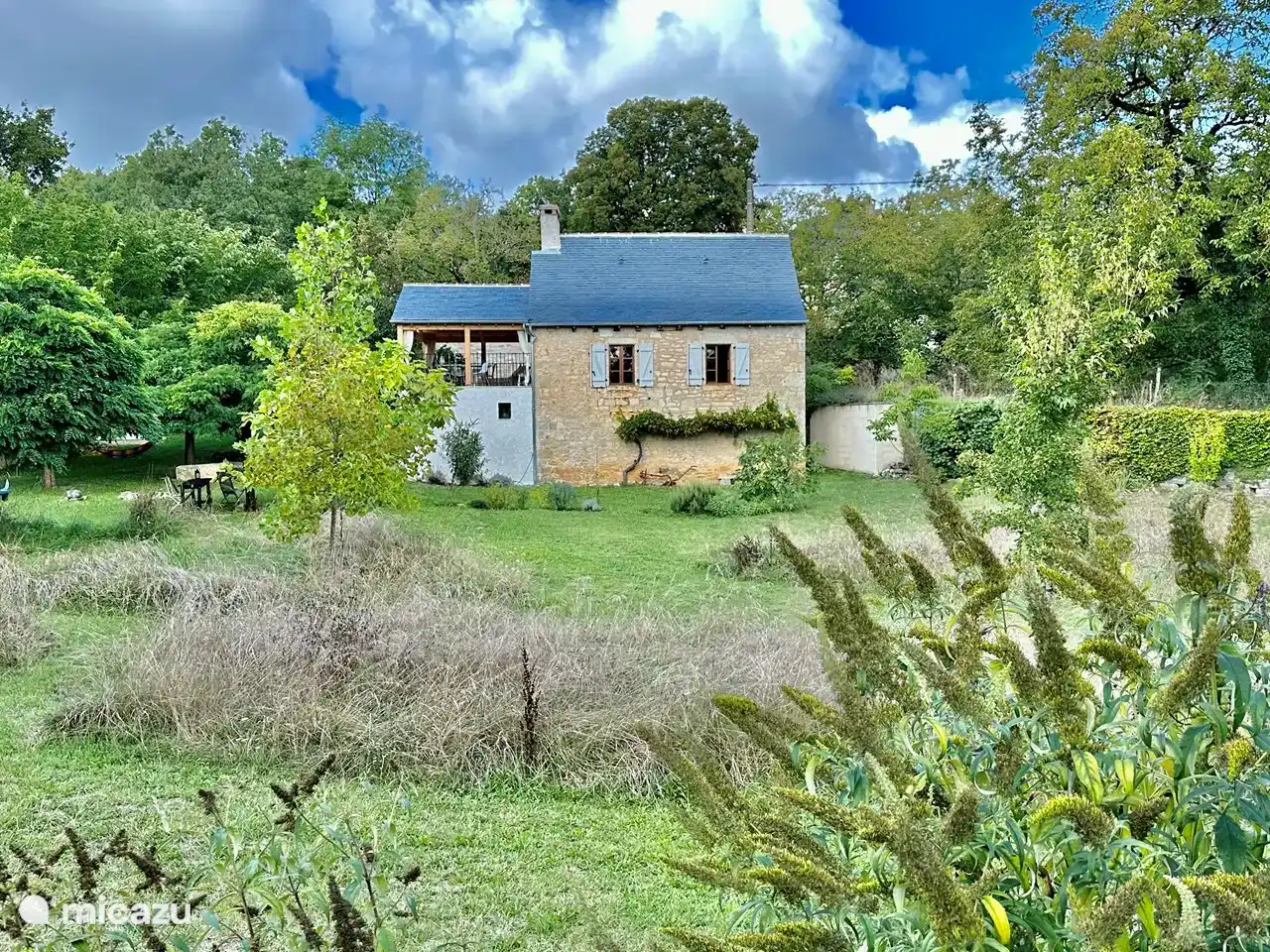 The house seen from the end of the garden. On the right the road leads to the house.