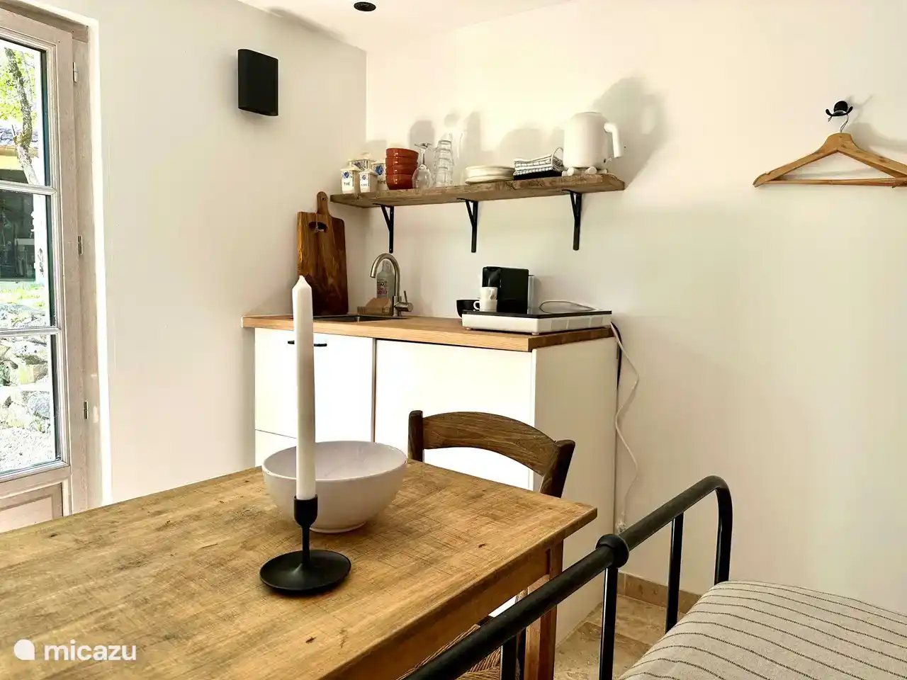 The small table in the studio, with the kitchen corner in the background.