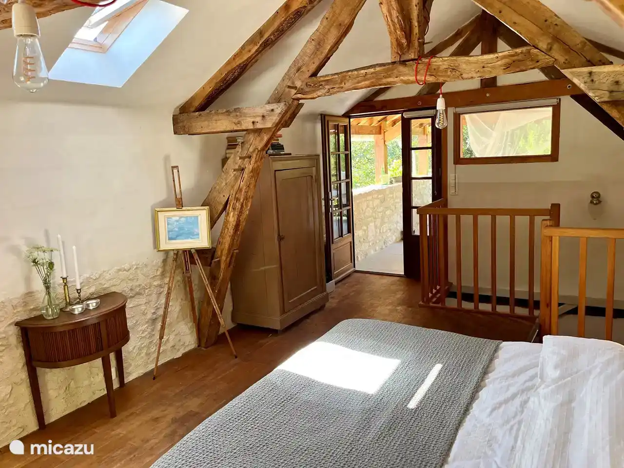 The door to the terrace at the large bedroom upstairs in the old barn, with coffee &amp; tea corner, cupboard, beautiful old table and double outdoor bed.