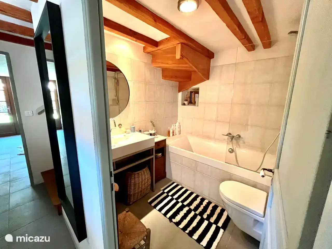 The bathroom with bath, shower, toilet and large sink in the old barn.