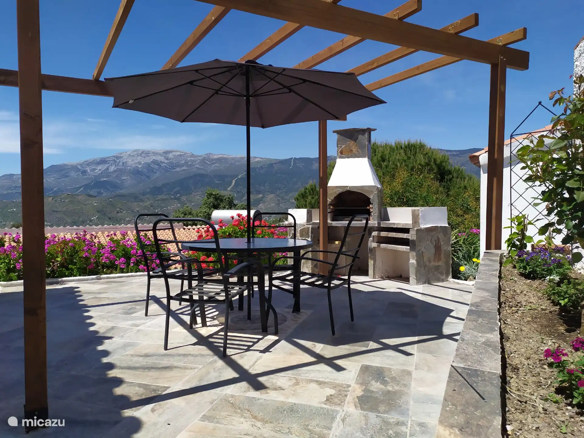Private terrace and barbeque with mountain views.