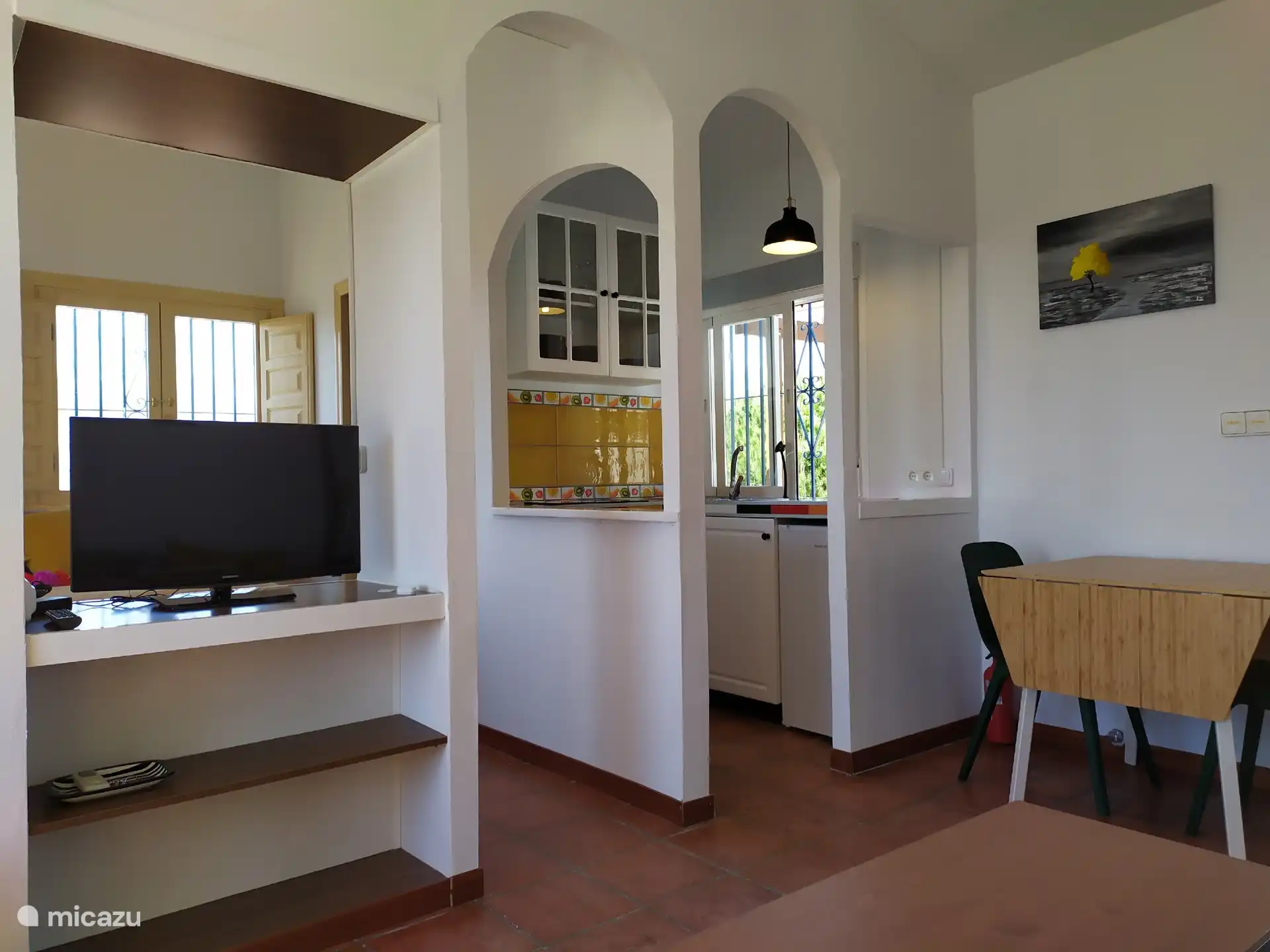 TV, kitchenette and extendable dining table.