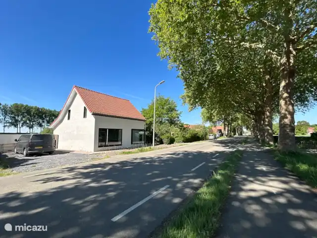 casa vacacional en Países Bajos, Zelanda, Philippine – Polderhuis Moderno Filipinas Frente de la casa con estacionamiento para 2 autos a la izquierda de la casa. Posiblemente estacionamiento adicional en la parte trasera de la casa