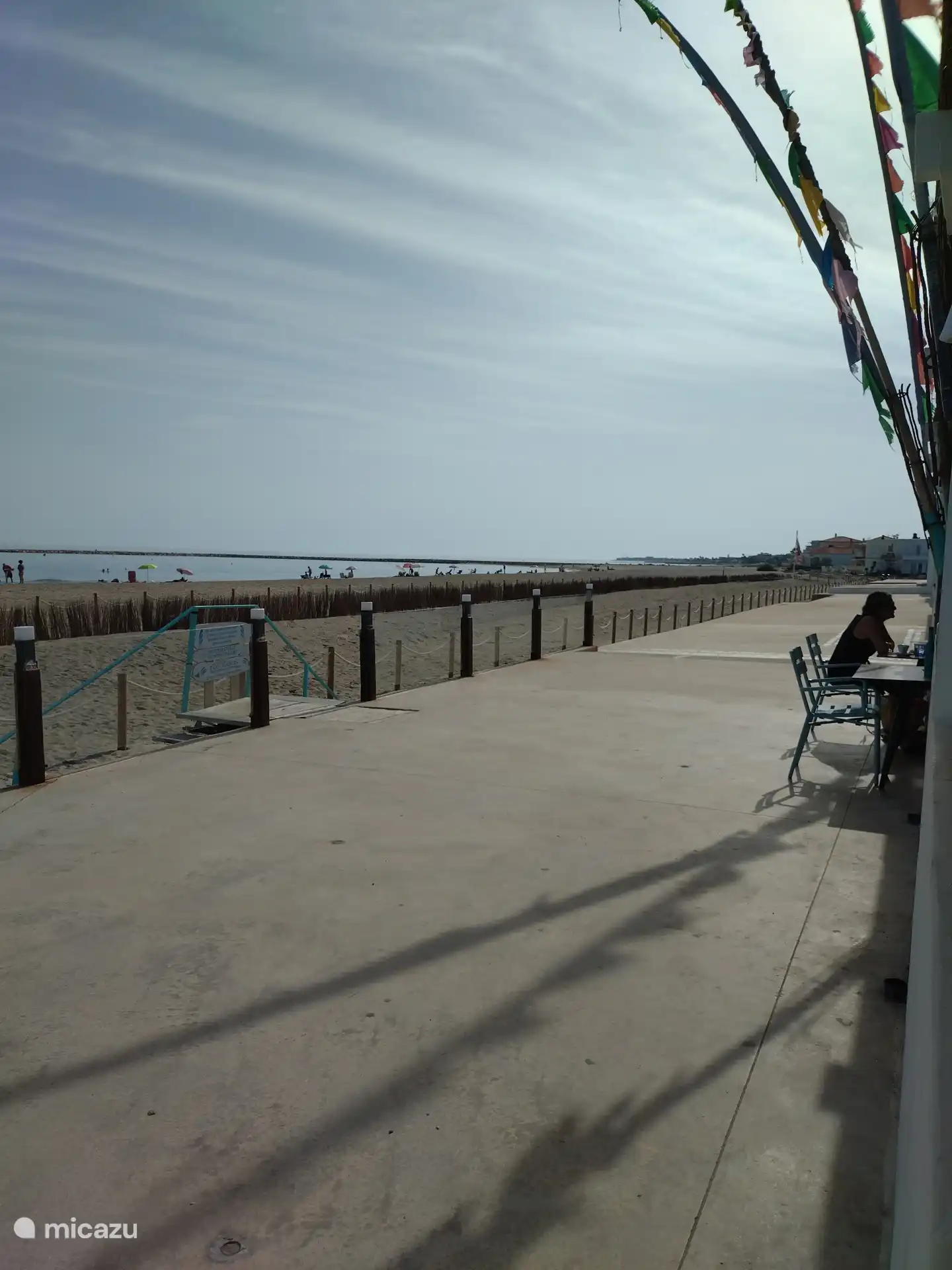 The spacious and long sandy beach of Platje de les Devenes.