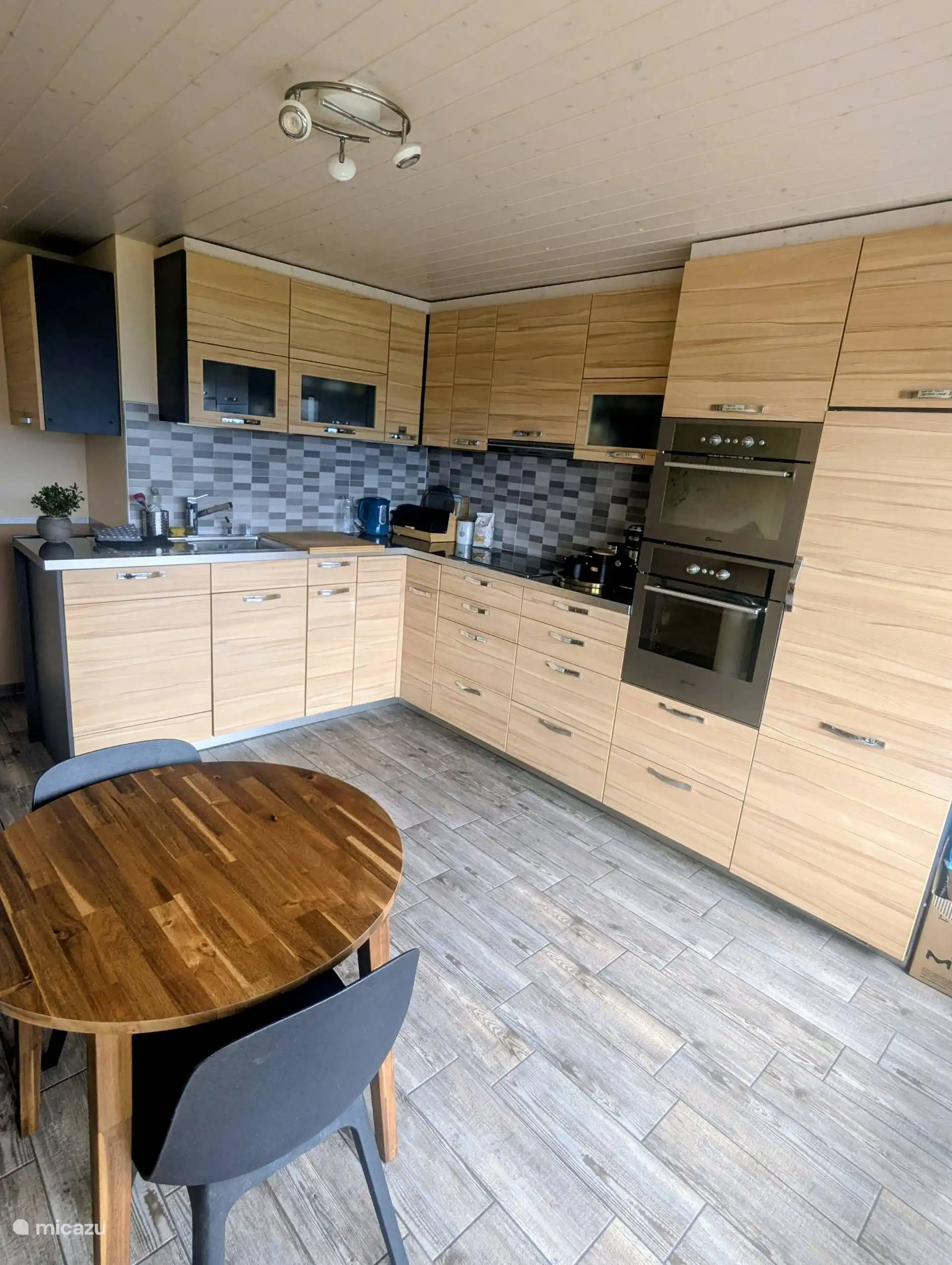 Large comfortable and fully equipped kitchen with small breakfast table.