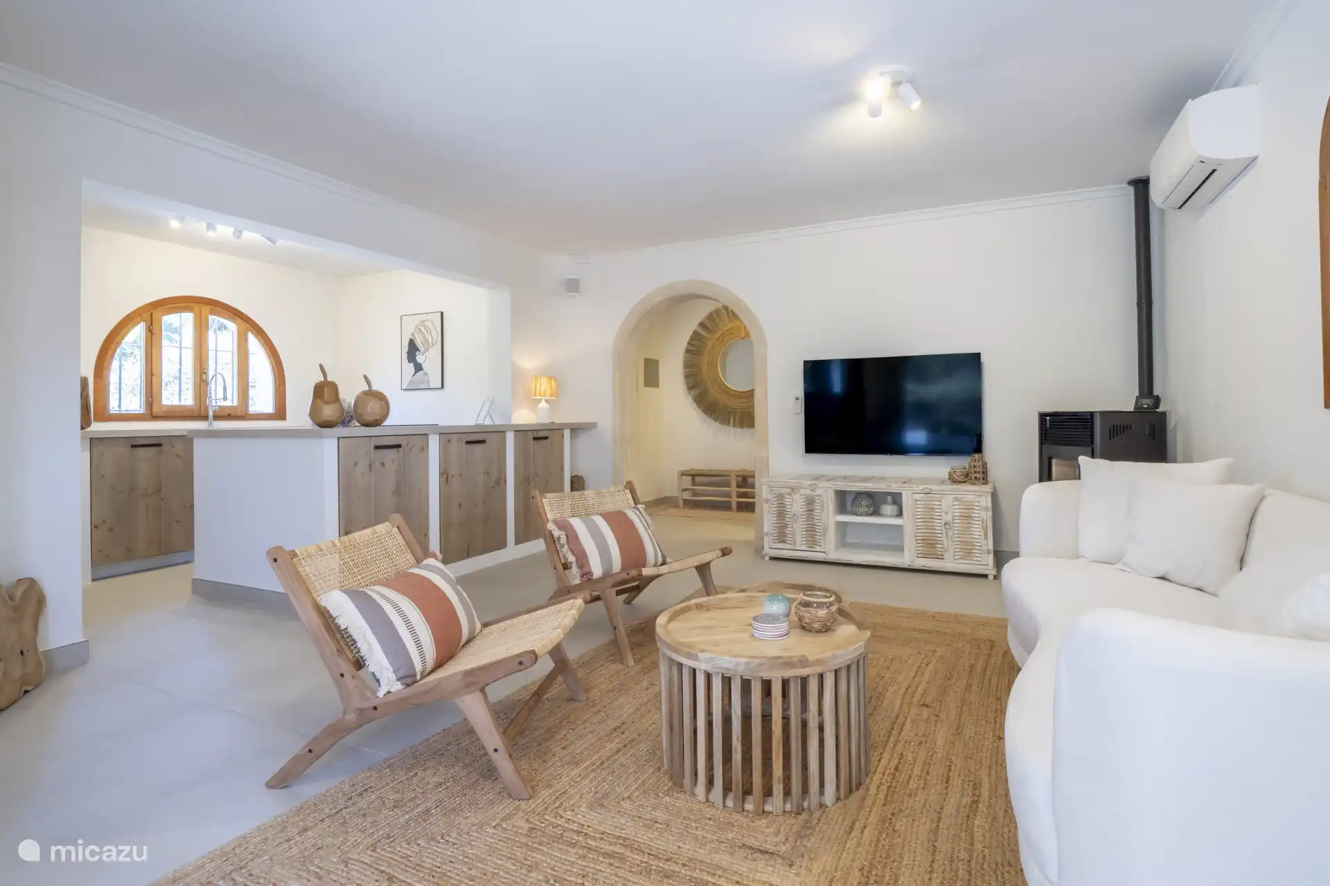 Elegante sala de estar con aire acondicionado, estufa de pellets y Smart TV.